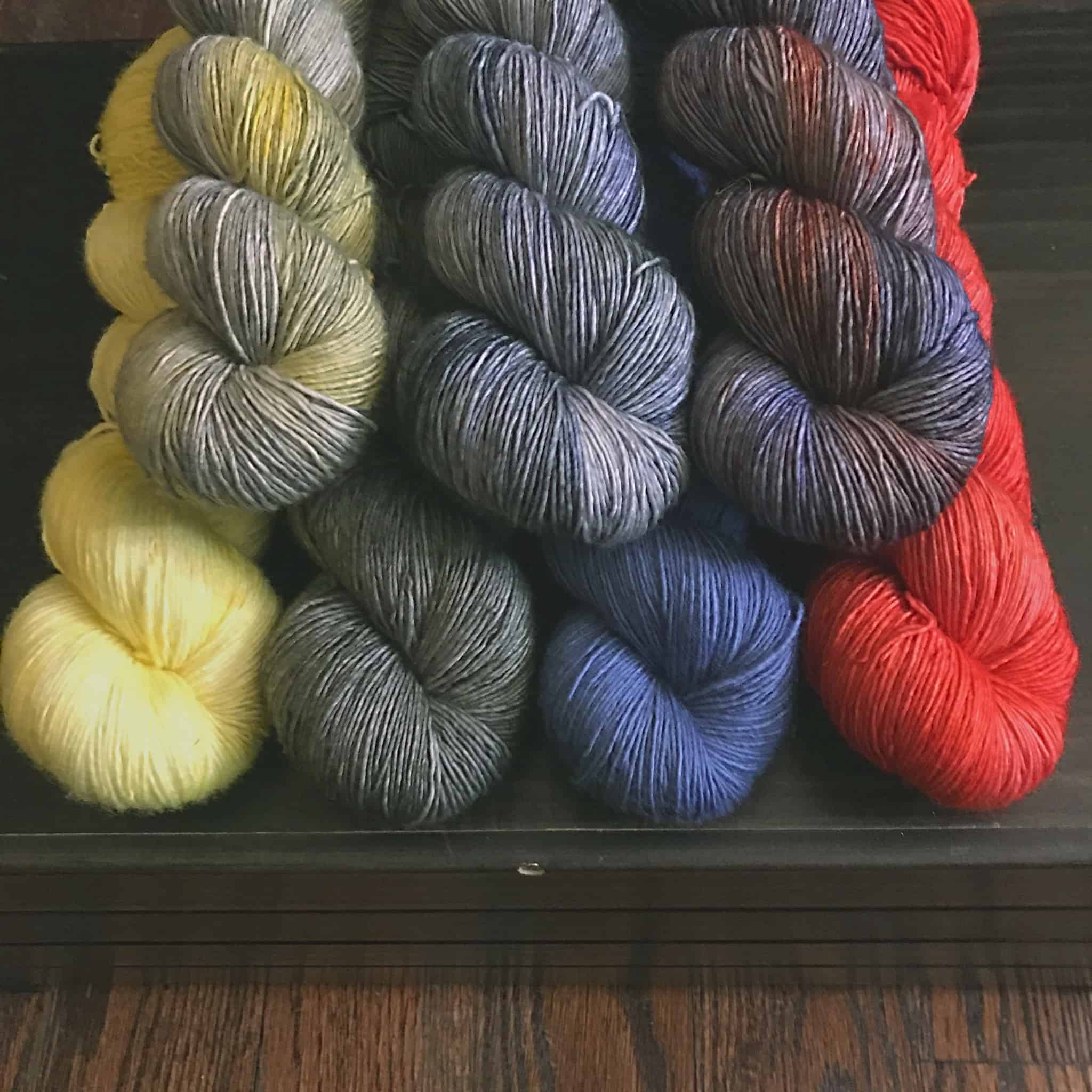 Gray, yellow, blue and red yarn.