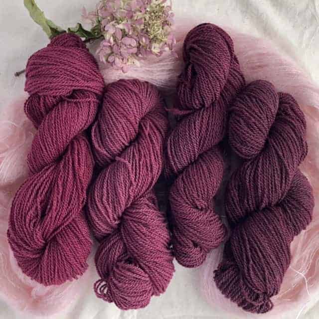 Four skeins of wine-colored yarn.