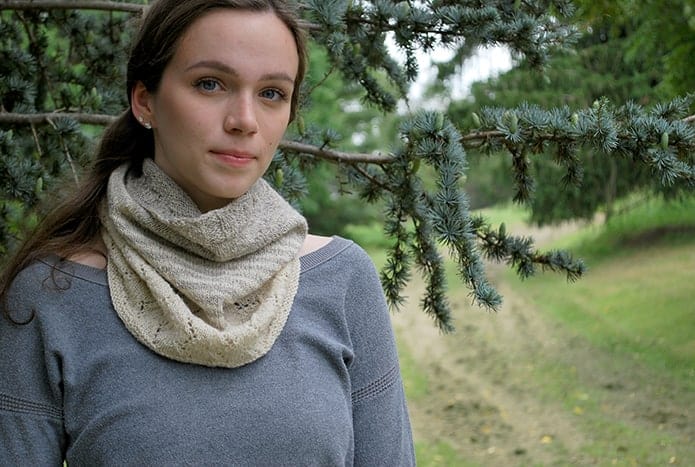 A woman models a lacy cream-colored cowl.