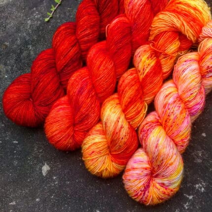 A four-skein fade set of red-orange yarn.