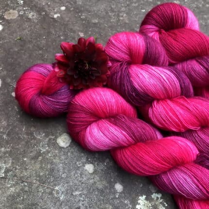 Hot pink and purple yarn with a pink flower.