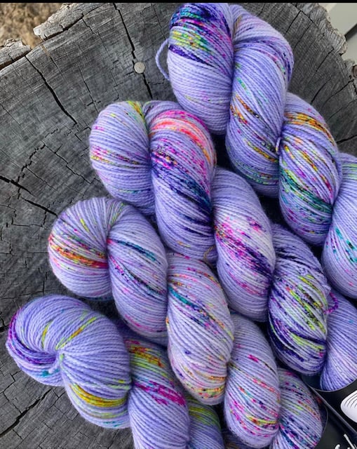 Bright lilac yarn with rainbow speckles.