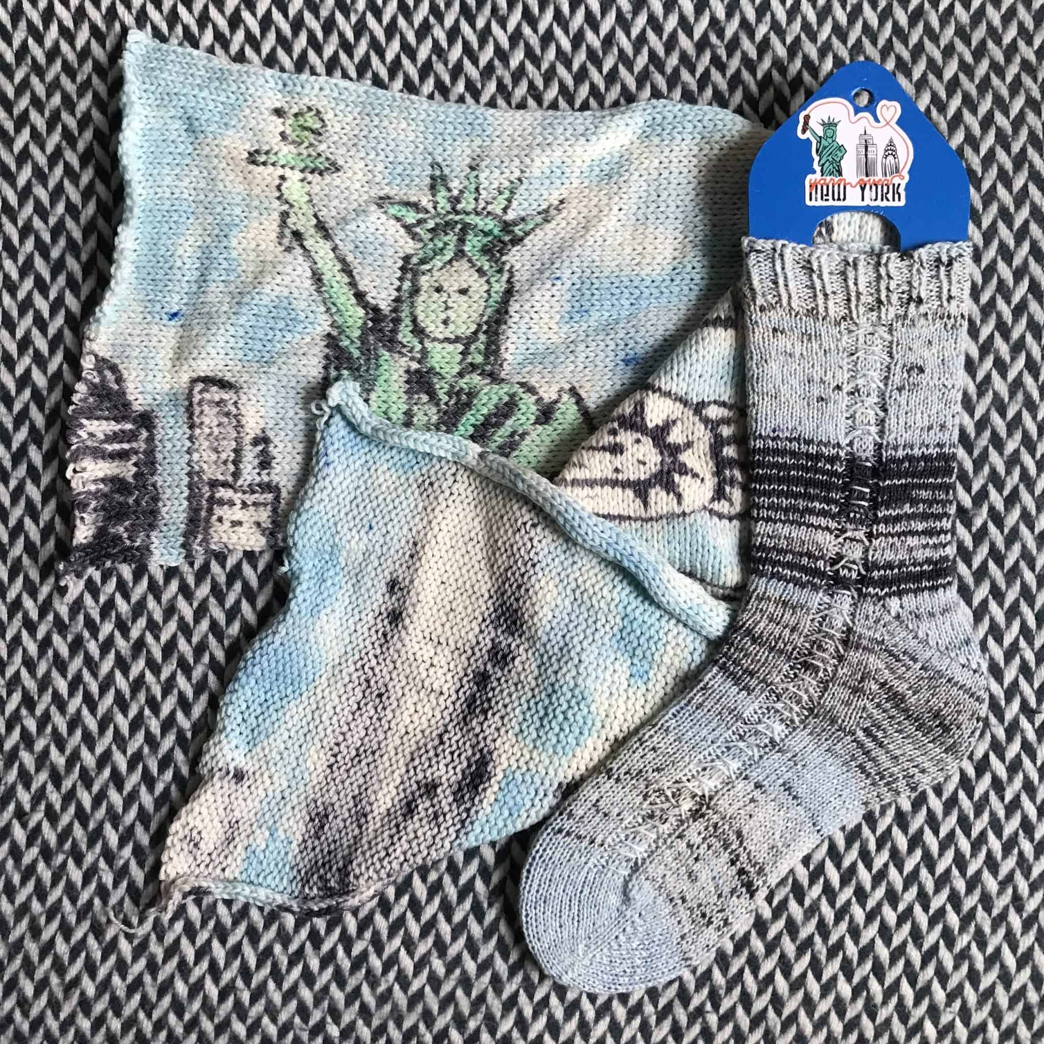 The Statue of Liberty and the NYC skyline on a piece of blue knitting. 