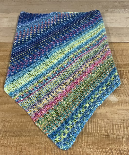 A blue, green and orange striped and slipped stitch cowl.