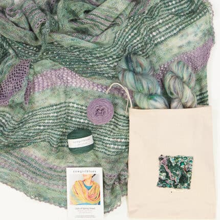 A green and purple shawl pictured with a cotton bag.