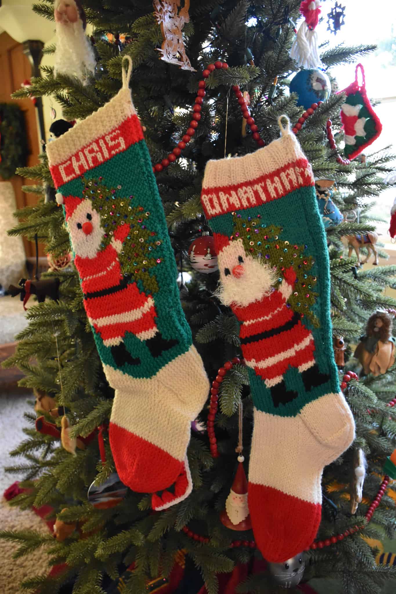 Green and red knitted Christmas stockings with Santa Claus.