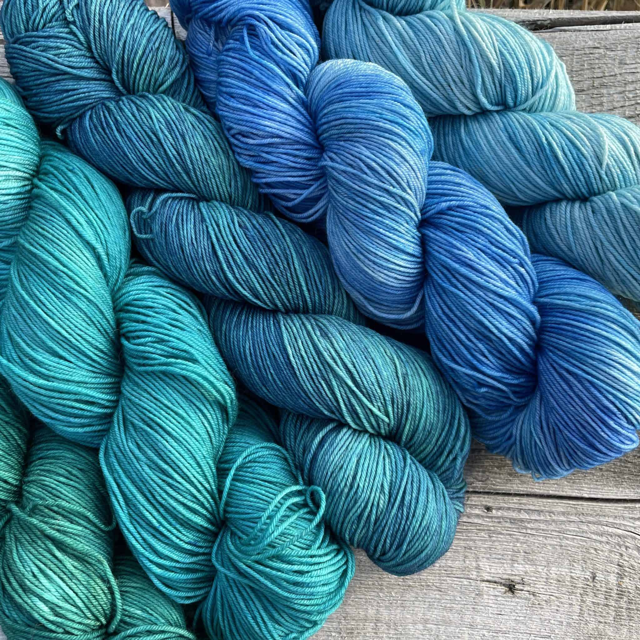 A set of hand-dyed yarn in a blue gradient.
