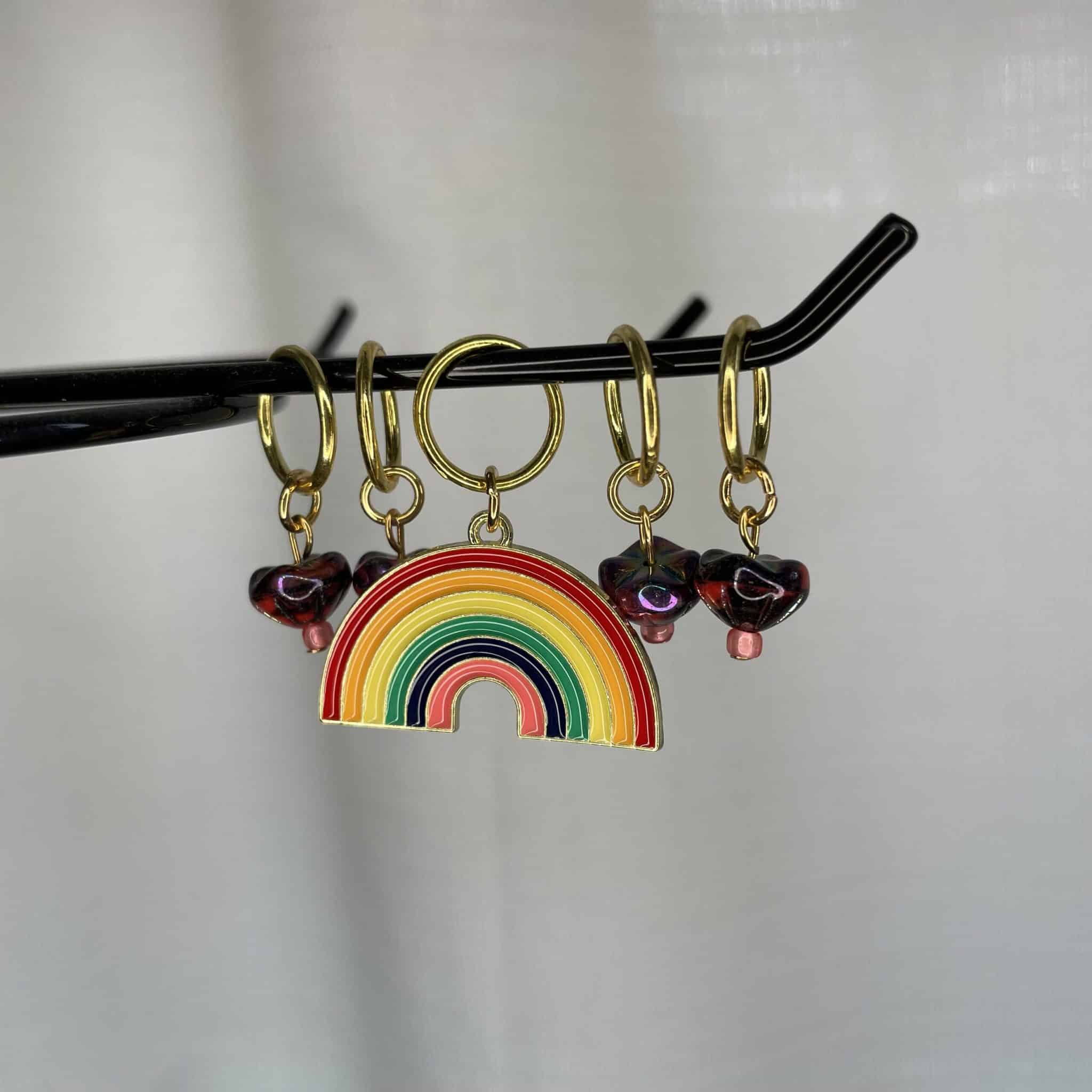 A rainbow surrounded by smaller beaded charms.