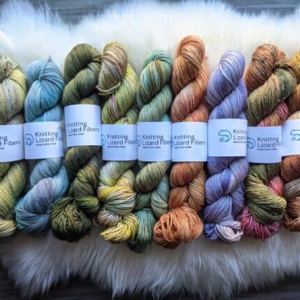 Skeins of hand-dyed yarn in pale colors.