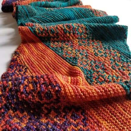 A mosaic shawl in red, orange and green.