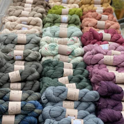 Piles of pastel-colored skeins of hand-dyed yarn.