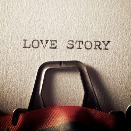 The phrase LOVE STORY viewed in a typewriter.