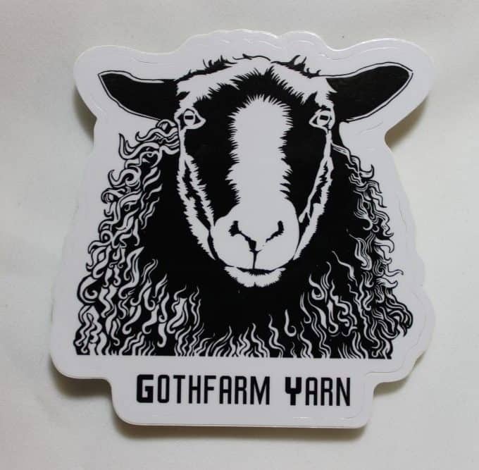 A sticker with a black sheep that reads Gothfarm Yarn.
