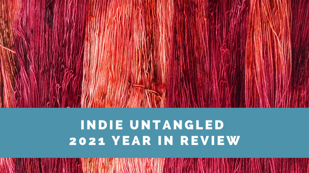 Red, orange and pink yarn and the words Indie Untangled 2021 Year In Review.