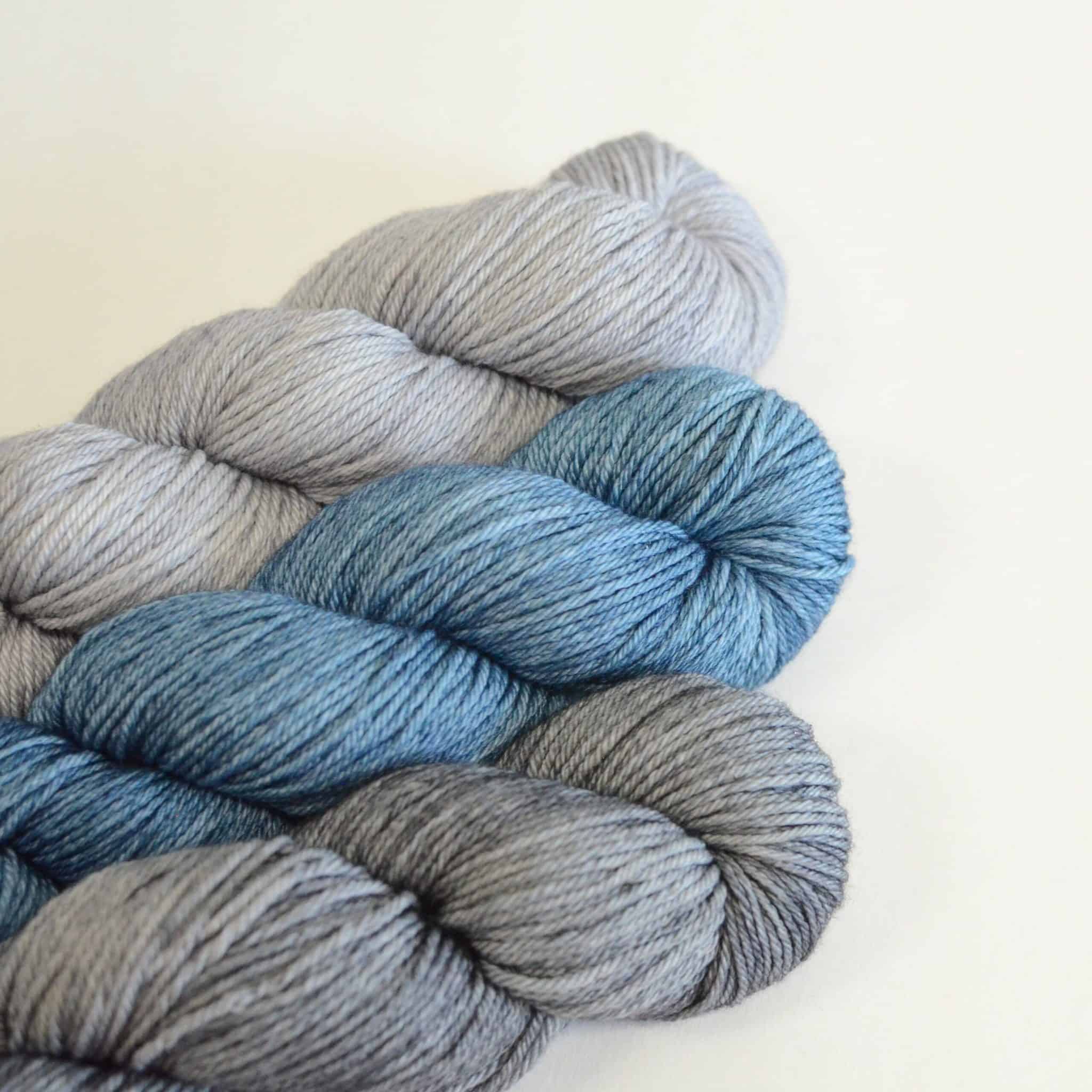 Skeins of gray and light blue yarn.