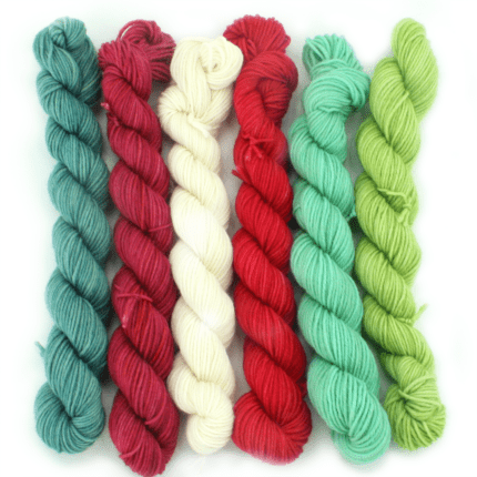 Skeins of hand-dyed yarn in shades of green and red.