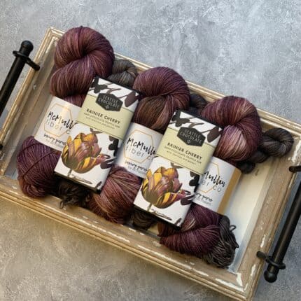 Rich black cherry yarn with soft speckles and deep chocolate mini skeins and a matching chocolate bar.
