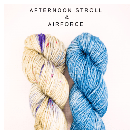 A skein of multi green, blue and pink toned yarn and a skein of semi solid blue yarn yarn the words AFTERNOON STROLL & AIRFORCE.