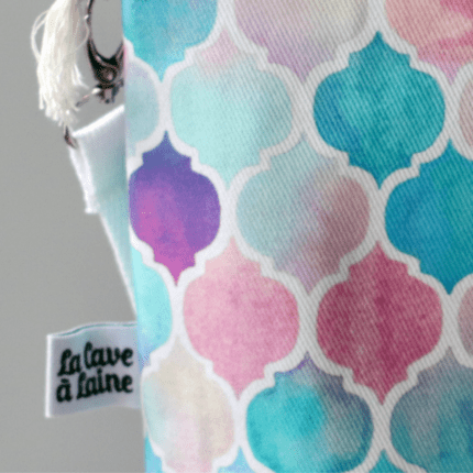 A close up on a bag made with pale blue, pink and purple cotton.