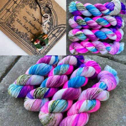 Pink, blue and green variegated yarns with a storybook green stitch marker.