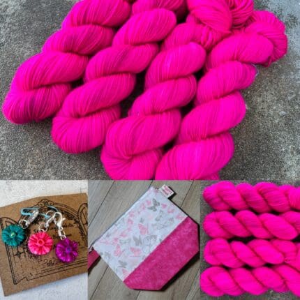 Skeins of bright hot pink yarn with a set of purple,teal and pink flower stitch markers. A project bag with pink bottom fabric and butterflies on it.