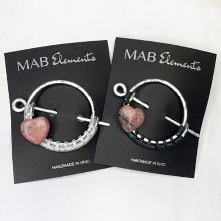 Silver shawl pins with pink rhodonite hearts and the MAB Elements logo, handmade in Ohio.