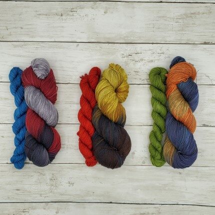 Three sock sets, each including a multicolored full size skein and a semisolid mini skein.