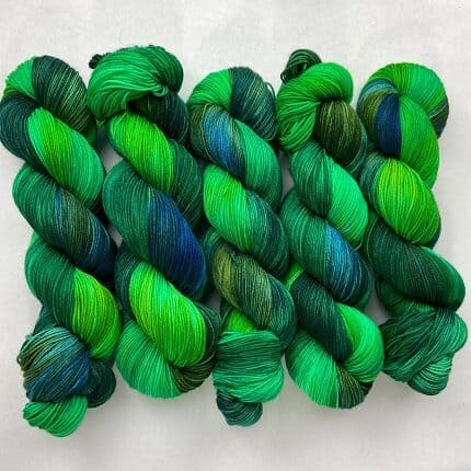Skeins of yarn in bright emerald greens and blues like a peacock's train.