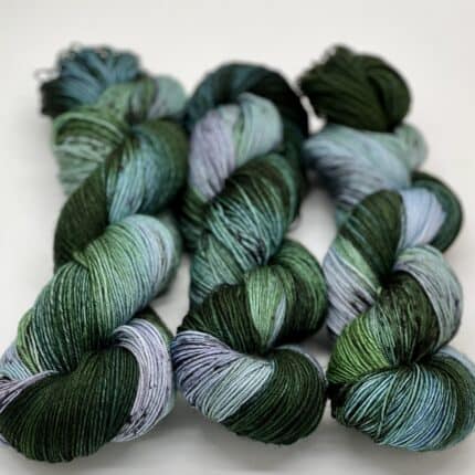 Blue, green and blue green skeins of yarn.
