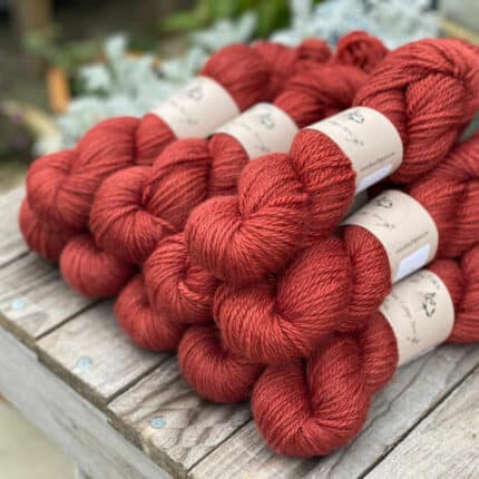 A pile of rich red skeins of yarn.
