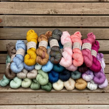 A pile of skeins of yarn in many different colours.