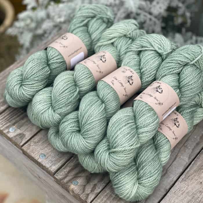 A pile of green skeins of yarn.