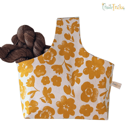 A project bag made from yellow flowered fabric.