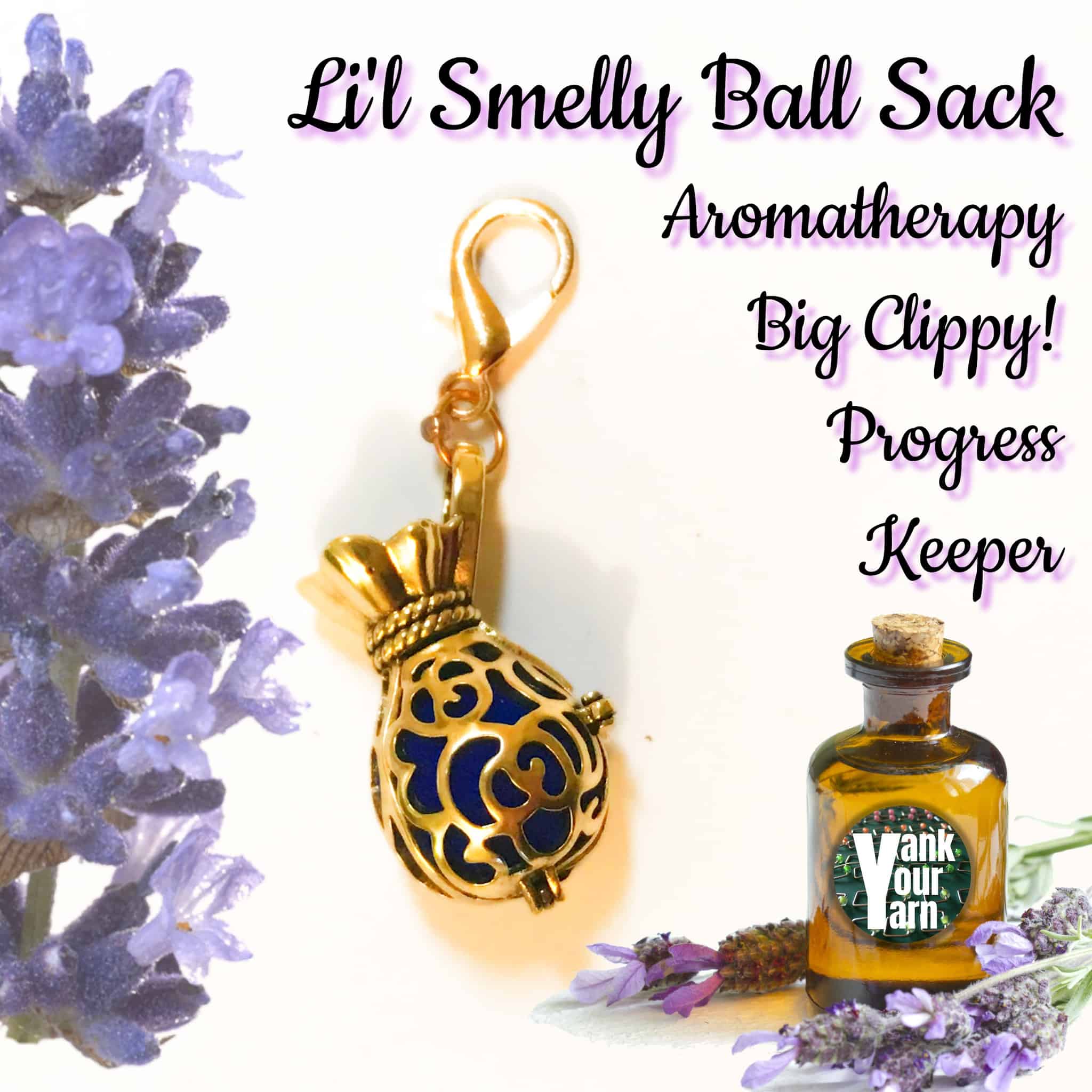 A large progress keeper-style stitch marker, on an oversized golden bronze lobster clasp with a filigree bronze essential oil pendant. The text Li'l Smelly Ball Sack - Aromatherapy Big Clippy! Progress Keeper.