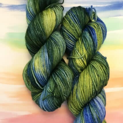 Two skeins of variagated yellow, blue and green yarn.