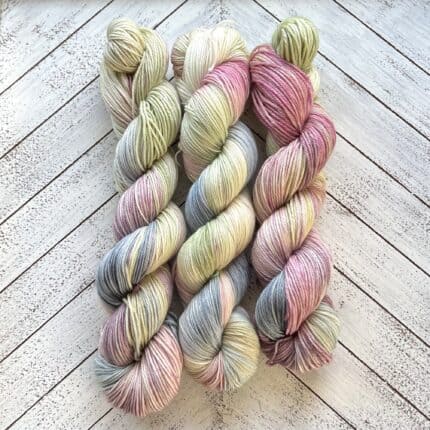 Three large skeins in pale blue, pink, and green.
