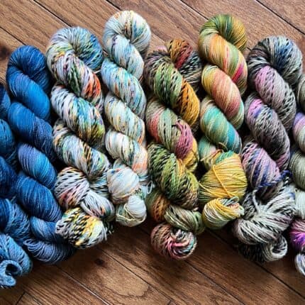 Brightly colored blue, orange and green yarns.