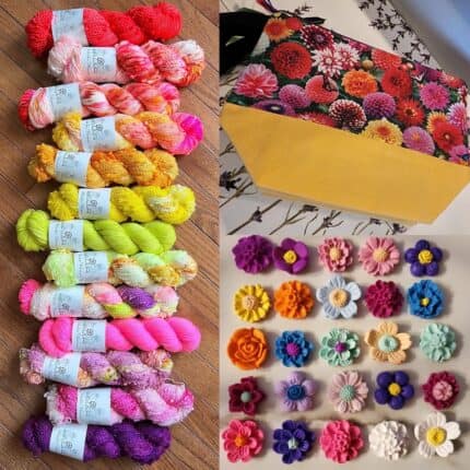 Skeins of brightly colored yellow, purple, pink and orange yarns. A flower patterned project bag and varying brightly colored flower charms.