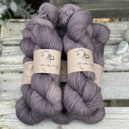Five skeins of purple laceweight yarn.