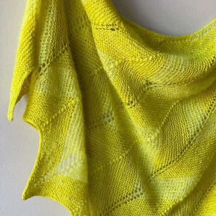 Chiffon shawl ends showing chevron peaks and valleys giving the bottom of your shawl a beautiful scallop finish along with the I-cord edges. Knit in bright lemon yellow of fingering and suri yarn.