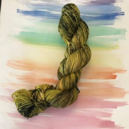 A skein of yellow yarn with black speckles.