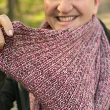 Close up of a pink knit cowl.