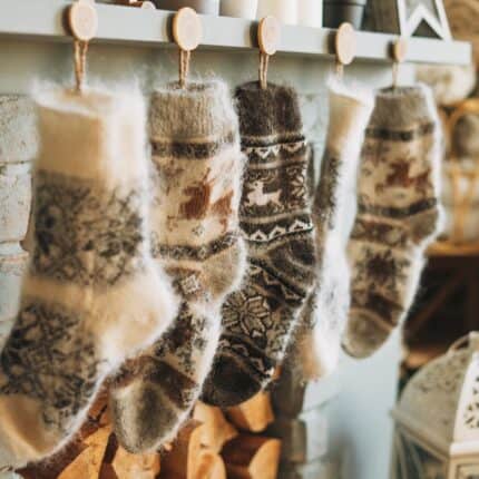Wool stockings in neutral colors hanging on a mantle.