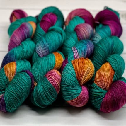Four dark aqua, Berry and mustard color assigned pooling skeins.
