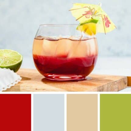 A photo of a red-colored drink in a glass with a tiny yellow umbrella, sitting on a wood cutting board. Next to it is a lime. Across the bottom are four squares in red, grey, beige and green.