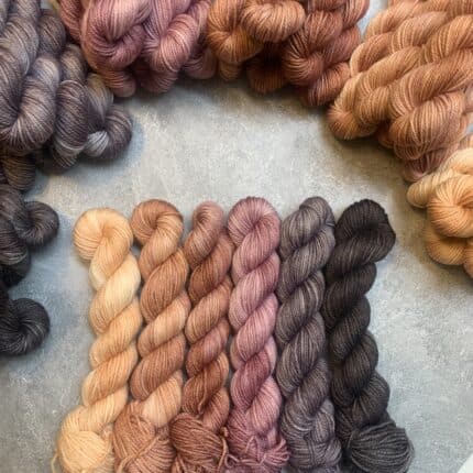 A gradient of mini skeins shifting from orange to black.