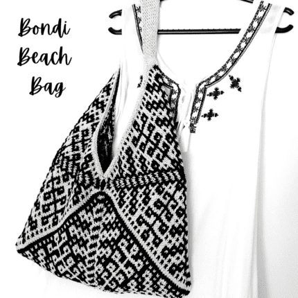 A black and white bag knitted in mosaic technique featuring an intricate colourwork pattern.