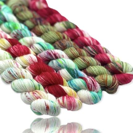 Multiple skeins of red and green yarn.