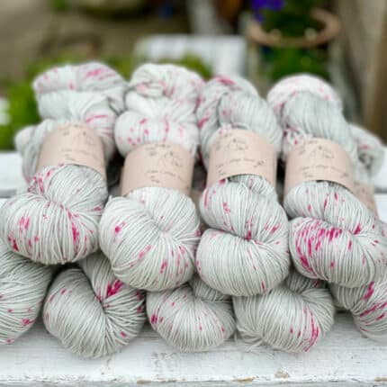 Grey yarn with pink speckles.