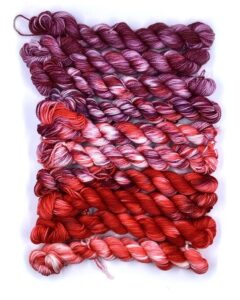 A set of purple and red gradient yarn.